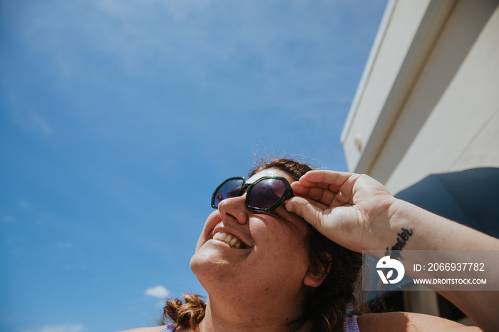 close up of woman’s face smiling towards the sun