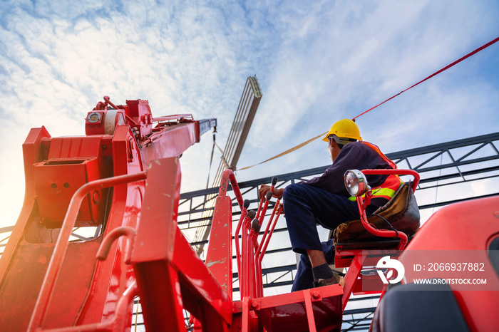 Asian Crane driver, Crane driver sit a top in a mobile crane cabin and working lifting the roof or PU foam roof sheet at the construction site.