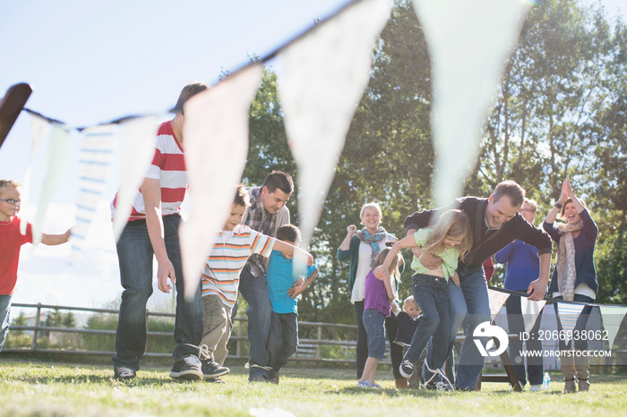 Family cheering family in 3 legged race event