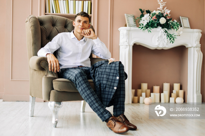 The groom is preparing to meet the bride, Elegant man in a suit posing in the studio, Wedding day