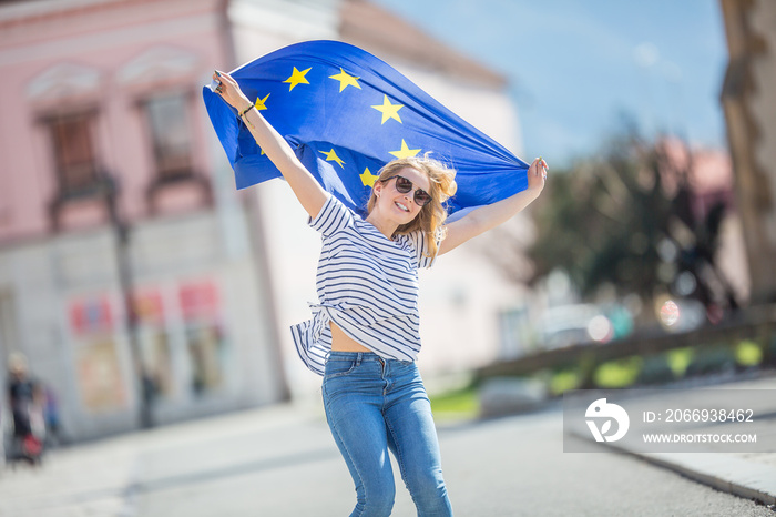 Attractive happy young girl with the flag of the European Union