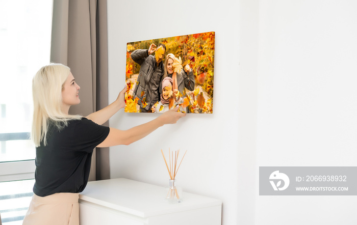 woman holding a photo of autumn, canvas