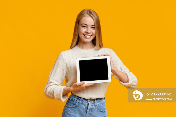 Digital tablet with black blank screen in young girl’s hands