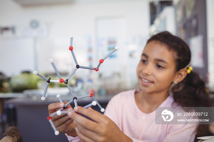 Elementary student holding molecule model