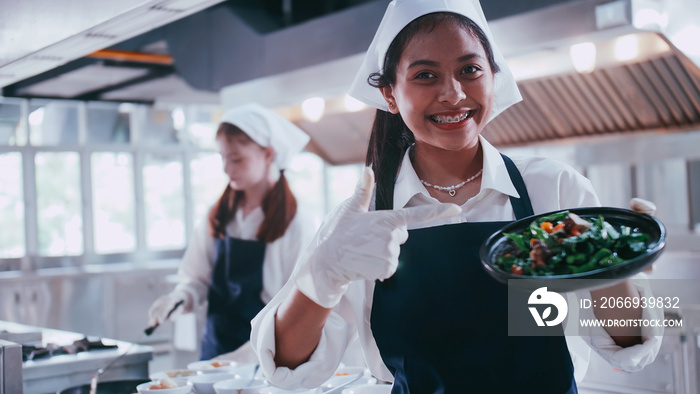 Group of schoolgirls having fun learning to cook. Female students in a cooking class.