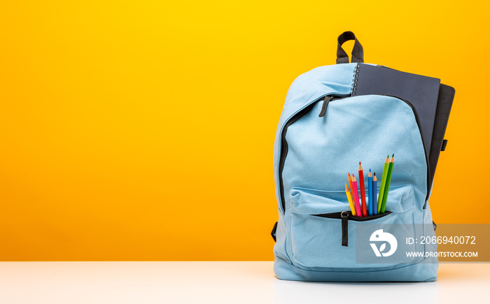 Back to school background. Stationery Supplies in the school bag. Banner design education On Yellow background.