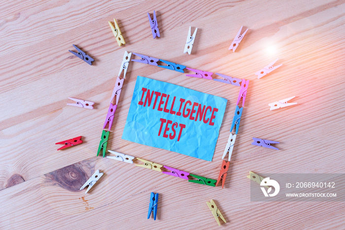 Conceptual hand writing showing Intelligence Test. Concept meaning test designed to measure the ability to think and reason Colored crumpled papers wooden floor background clothespin