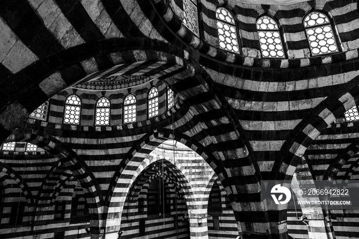 Damascus Bazaar Caravanserai, roadside inns for weary travelers and their animals especially in Middle East and along Silk Road. Ablaq black and white architecture in Khan As’ad Pasha.