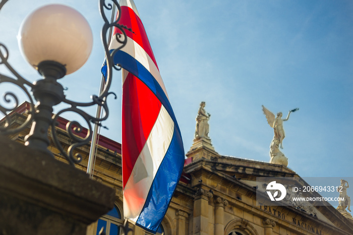 The flag of Costa Rica waving against the sun at the heart of San José