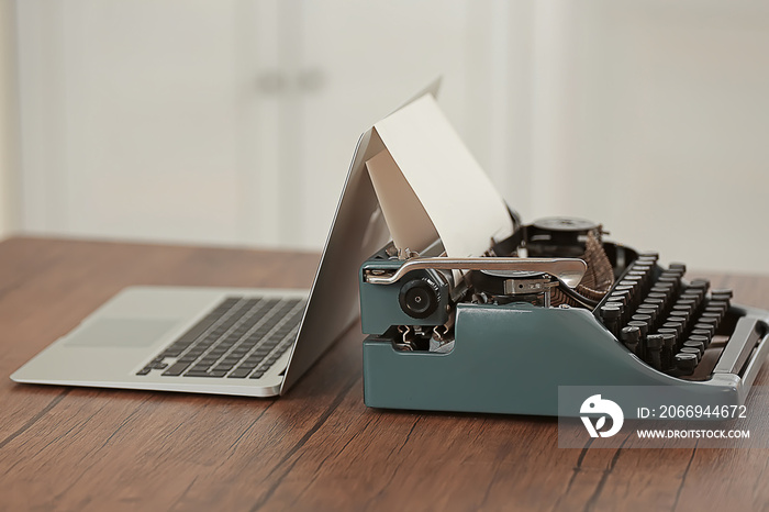 Old typewriter and laptop on table. Concept of technology progress