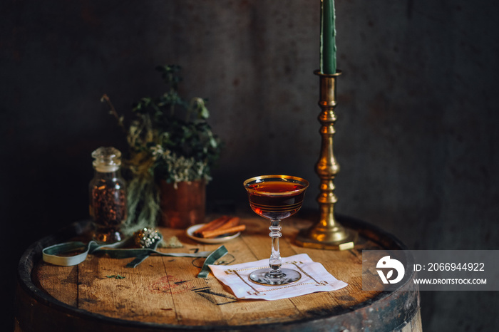 still life with Manhattan whiskey cocktail on bourbon barrel