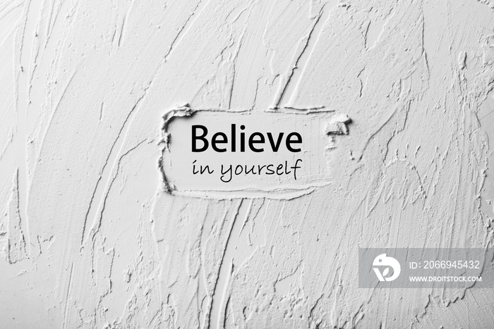 White and grey putty or oil abstract background with text believe in yourself