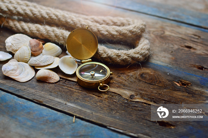 Nautical background. Old deck with rope, compass and shells.