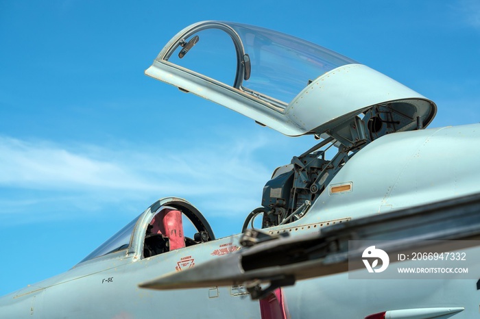 Hornet fighter jet reflects the sunshine - falcon cockpit under opened canopy at air show. Cockpit Of Fighter Jet with copy space.