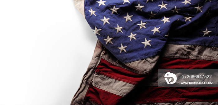 Wrinkled, aged, and worn US American flag with with blank white copy space.