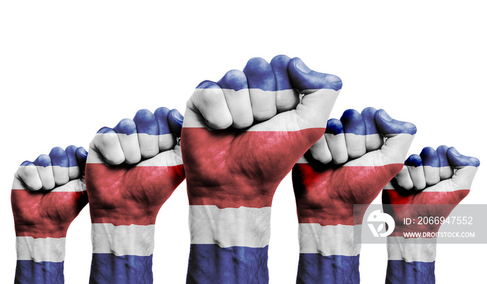 A raised fist of a protesters painted with the Costa Rica flag