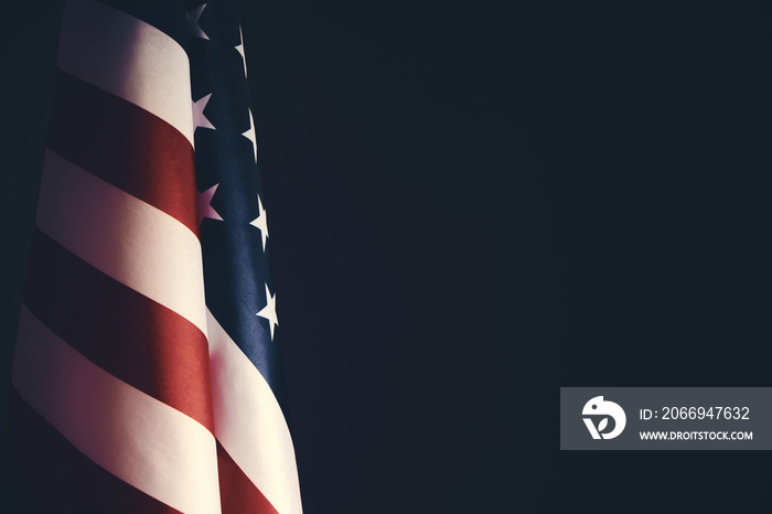 Standing flag United States of America on dark gray background.Banner of America in retro style.