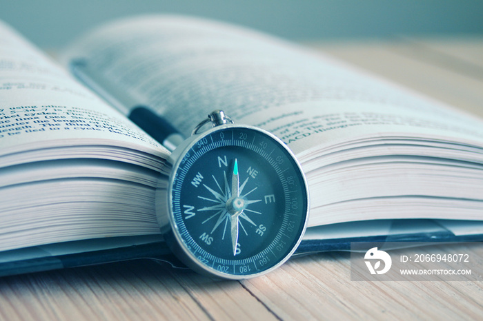 Compass and book on the table.