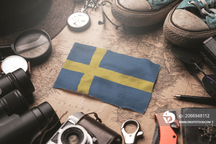 Sweden Flag Between Traveler’s Accessories on Old Vintage Map. Tourist Destination Concept.