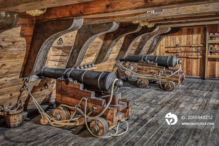 cannons in the hold of an old pirate ship.