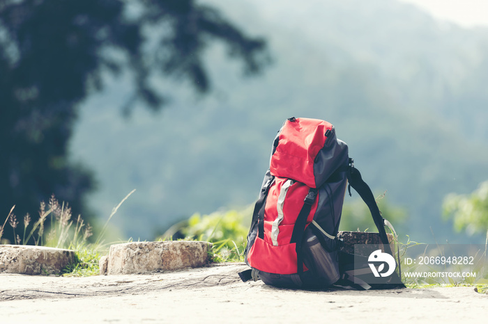 Hiking backpack travel gear on mountain. Items include hiking boots, cup, map, binoculars for travel destination and leisure in vacation.  outdoor travel equipment items