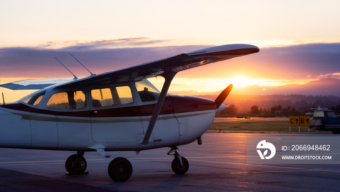 Airplanes parked at an Airport during a colorful summer sunset. Pitt Meadows, Vancouver, British Columbia, Canada