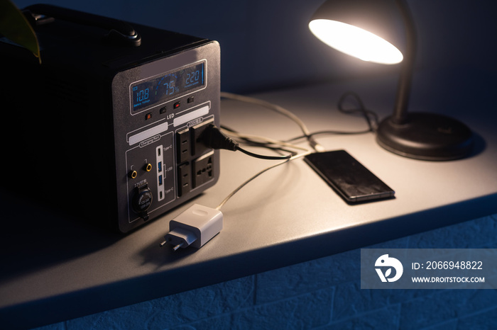 Portable power station charging tablet computer on table in living room