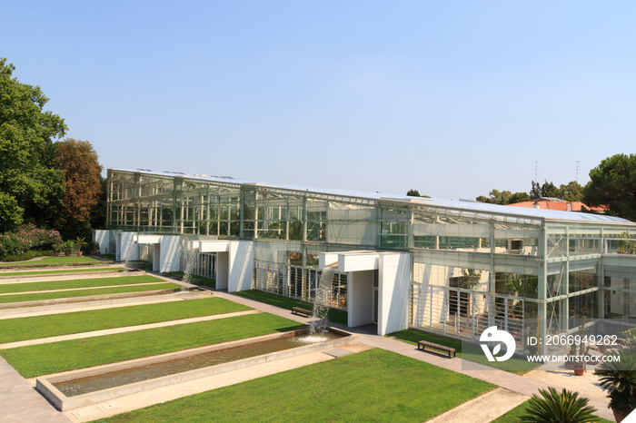 Greenhouse with artificial waterfalls in botanical garden (Orto botanico) in Padua, Italy