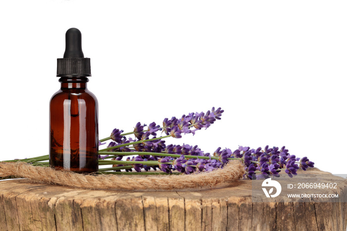 Mock-up, dropper and lavender flowers arranged on a wooden tabletop. White background, copy space.