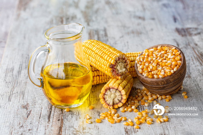 Corn essential oil bottle, corn groats, dry seeds and corncobs