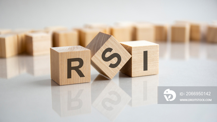 RSI - Relative Strength Index acronym concept on cubes, gray background