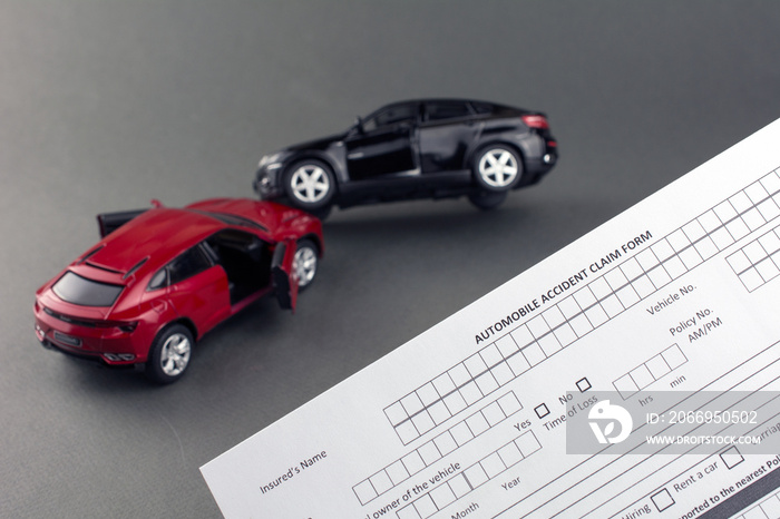 two toy broken cars and car insurance document. compare car insurance concept. gray background