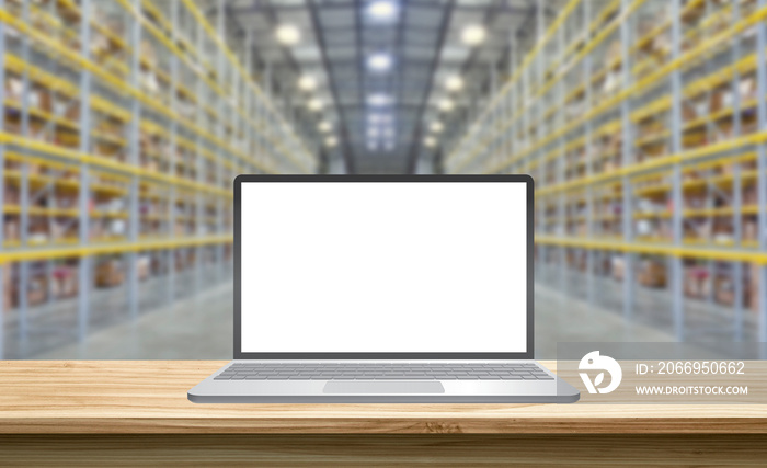 laptop with blank screen standing on a wooden table in a storehouse, mockup concept