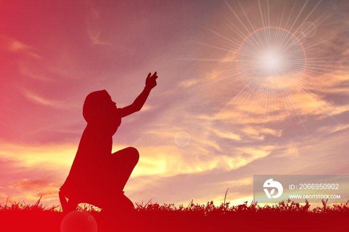 The concept of religion.Silhouette of children  praying at sunset