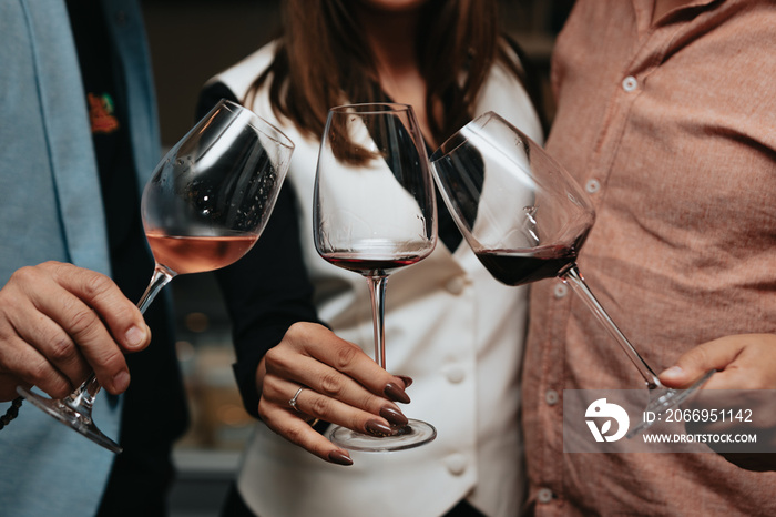 Red wine by the glass at a tasting of white, rosé and red wines that celebrates friendship and joy at the highest level with your best friends on a weekend evening full of people from social media.