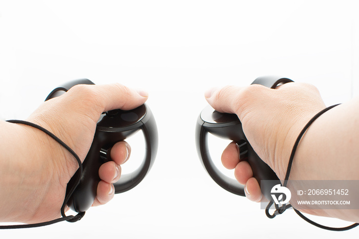 Virtual Reality Controllers Being Held By Adult Male Hands On White Background.