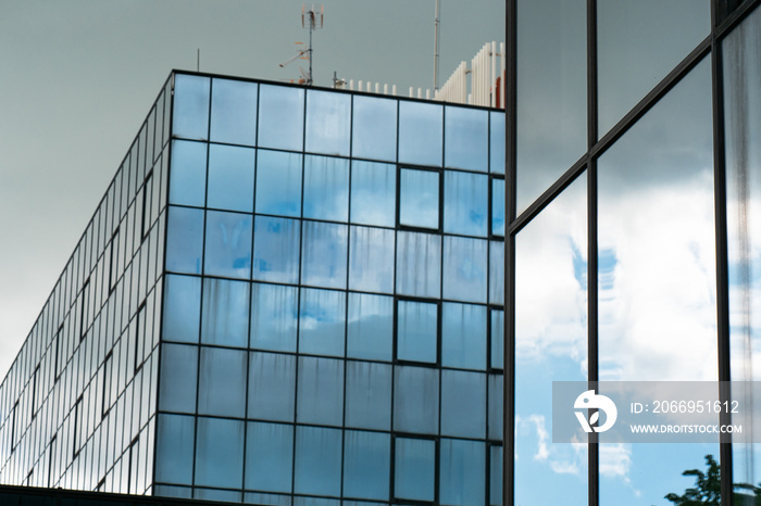 Modern Building Glass Facade Reflecting Cloudy Blue Sky