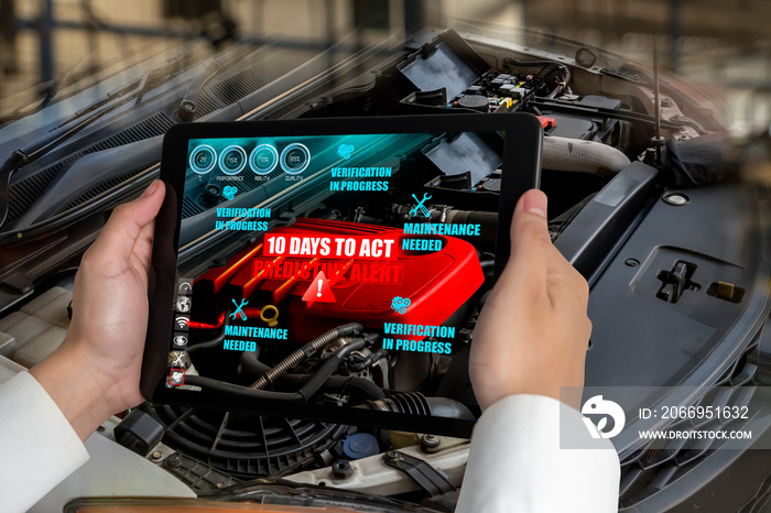 Engineer use augmented reality software to monitor parts of car vehicle with automated application . Futuristic machinery in working in concept of Industry 4.0 or 4th industrial revolution.