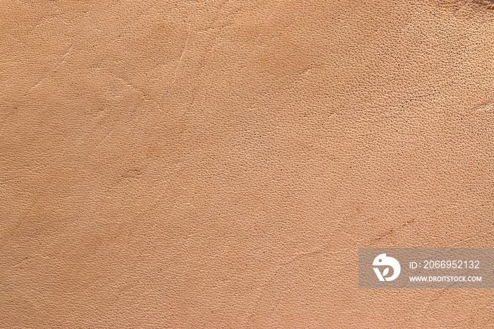 Natural vegetable tanned leather closeup macro full frame texture showing top grain and scratch wear marks