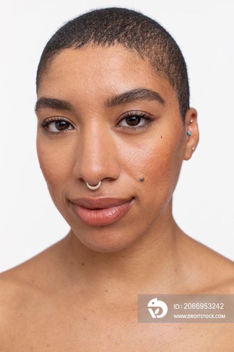 Studio portrait of woman with short hair and nose ring