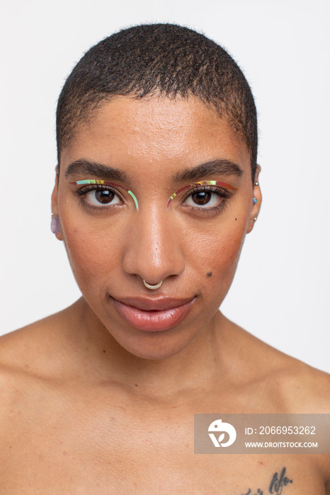 Studio portrait of woman with golden foil make-up