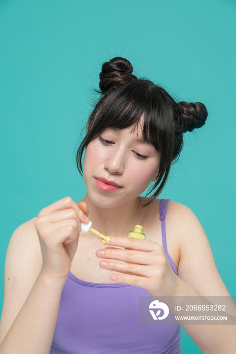 Studio portrait of girl painting nails