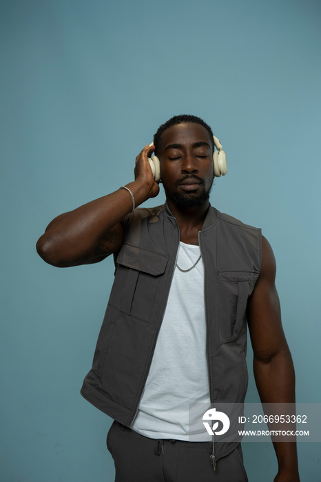 Man wearing vest and listening to music