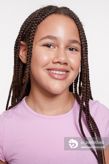 Studio portrait of smiling girl with braided hair