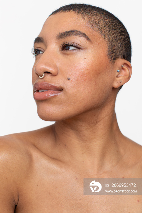 Studio portrait of woman with short hair and nose ring