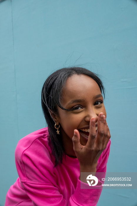 Portrait of young woman laughing outdoors