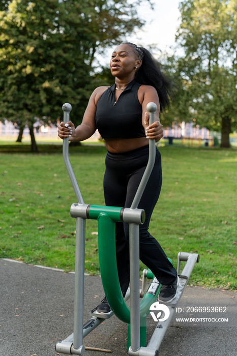 Young woman exercising in outdoor gym