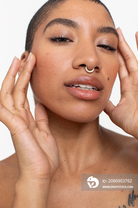 Studio portrait of woman with short hair and nose ring