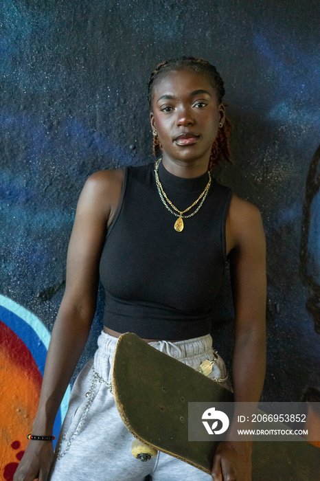 Portrait of young female skateboarder