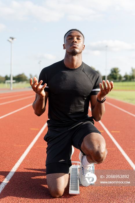 Athlete preparing to sprint at running track